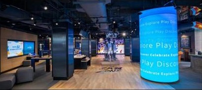 Explore Play Discover illuminated blue column in store